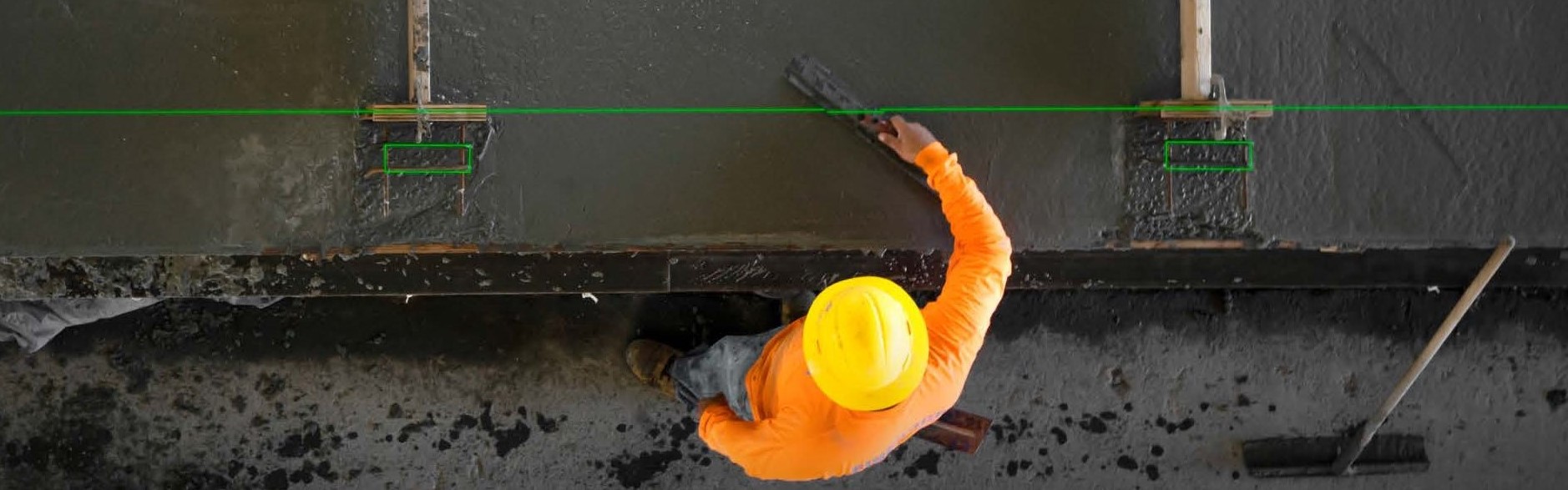 worker using laser-guided technology with precast