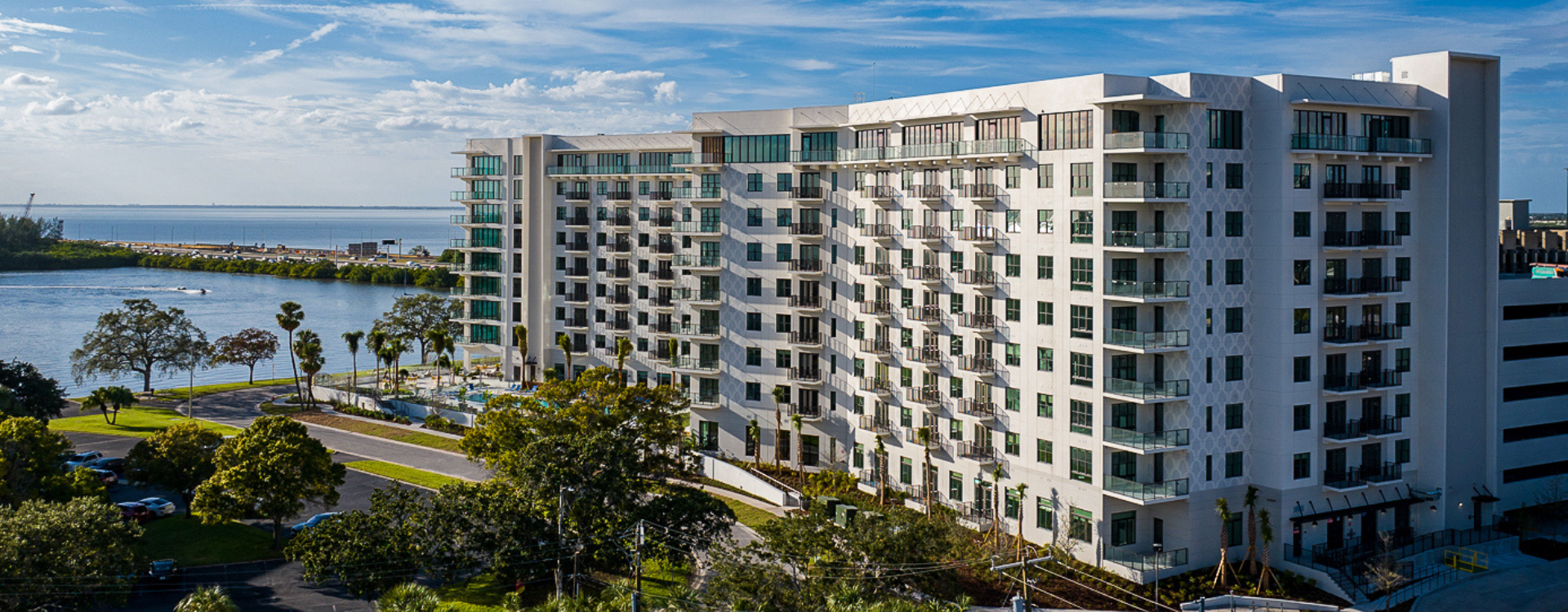 FUll building view of NOVEL Beach Park and Tampa Bay in the background